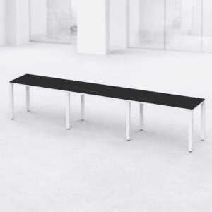 Mesa larga de oficina moderna y minimalista en espacio luminoso.